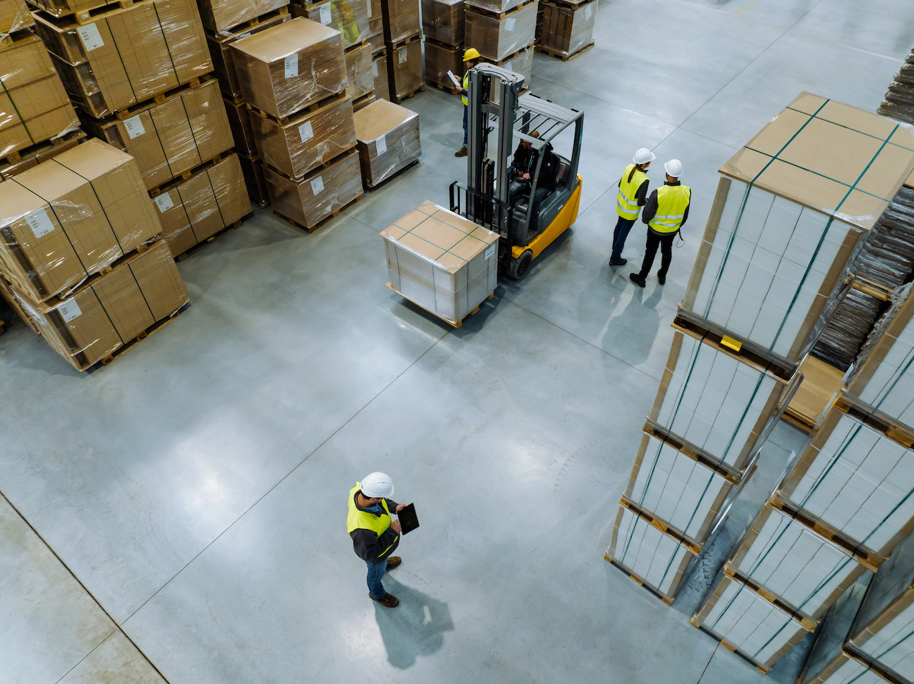 Employees in modern industrial factory with warehouse.